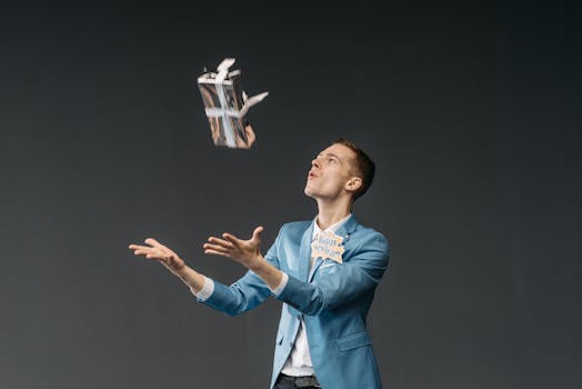 Person in a blue blazer tossing a gift with a Happy New Year tag in a studio setting.