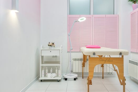 Interior of modern beauty salon with assorted skin products and couch for clients placed against window covered with shutters