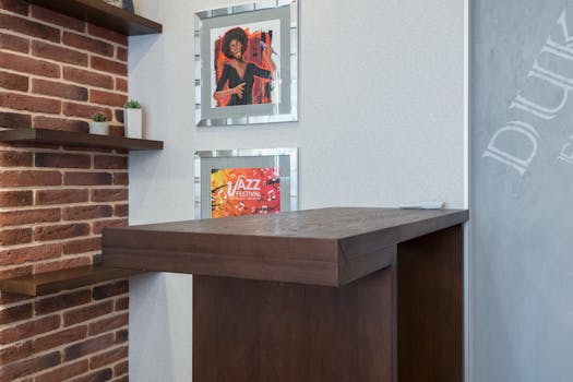 Modern home interior featuring a brick wall, wooden bar, and framed jazz festival art.