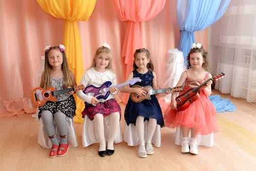 Four young girls playing toy guitars against a vibrant curtain backdrop.