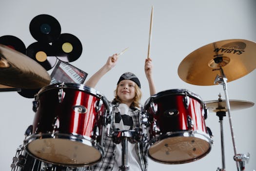 Energetic child drummer playing in stylish music studio with enthusiasm and skill.