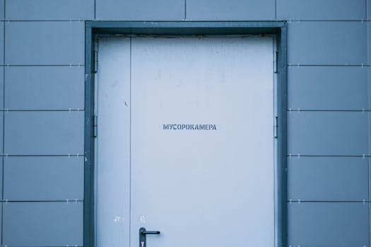Sleek industrial doorway in Moscow, featuring a minimalist design against a grey wall.