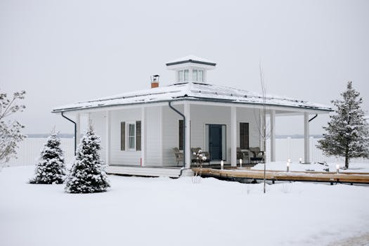 A charming snow-covered house amidst a serene winter setting, perfect for holiday season vibes.