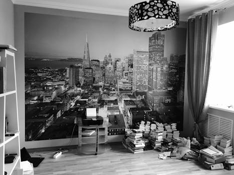 Stylish room featuring a black and white cityscape mural with books and modern decor.