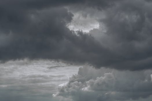 Moody gray storm clouds fill the sky in Краснодар, Россия, showcasing a dramatic weather scene.